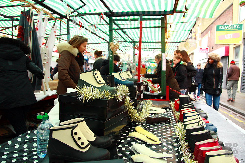 Market stall selling ankle wet weather boots.