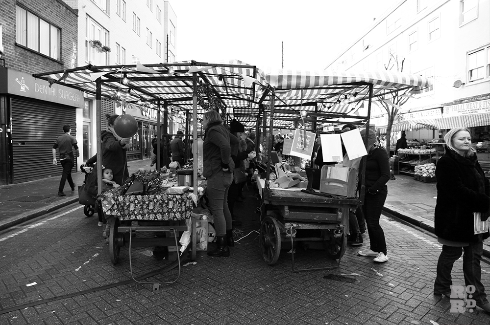 Old fashioned market stall rigs in East End Roman Road Market.