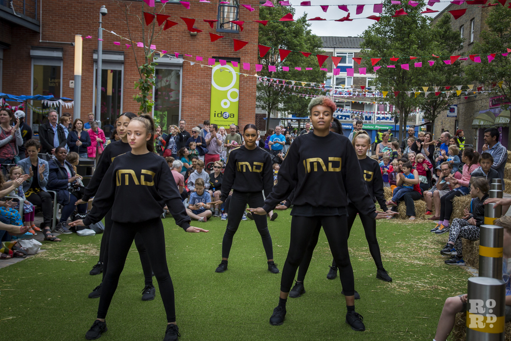 IMD Legion dance crew performing on artificial grass lawn at Roman Road Summer Festival