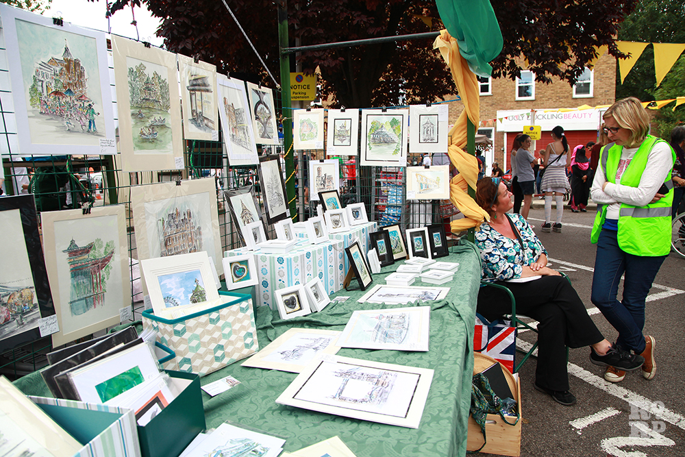 Market stand selling local art and prints at Roman Road Festival