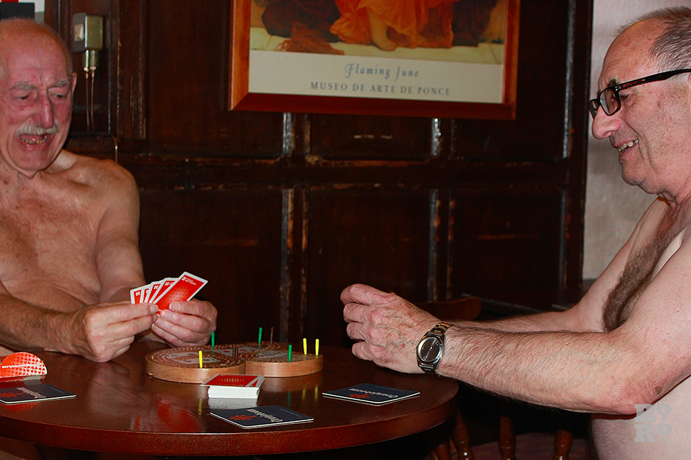 Two nude old men playing cribbage in British pub