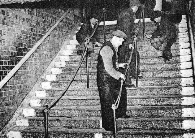 Day after Bethnal Green air-raid disaster in March, 1943, installing safety barriers at Bethnal Green Tube.
