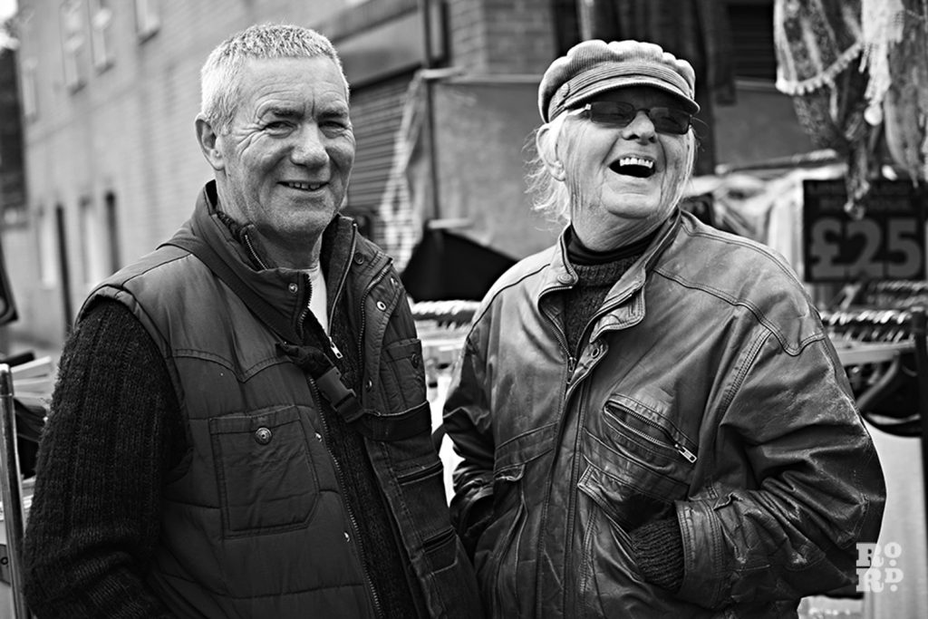 Two men on roman road market black and white photography