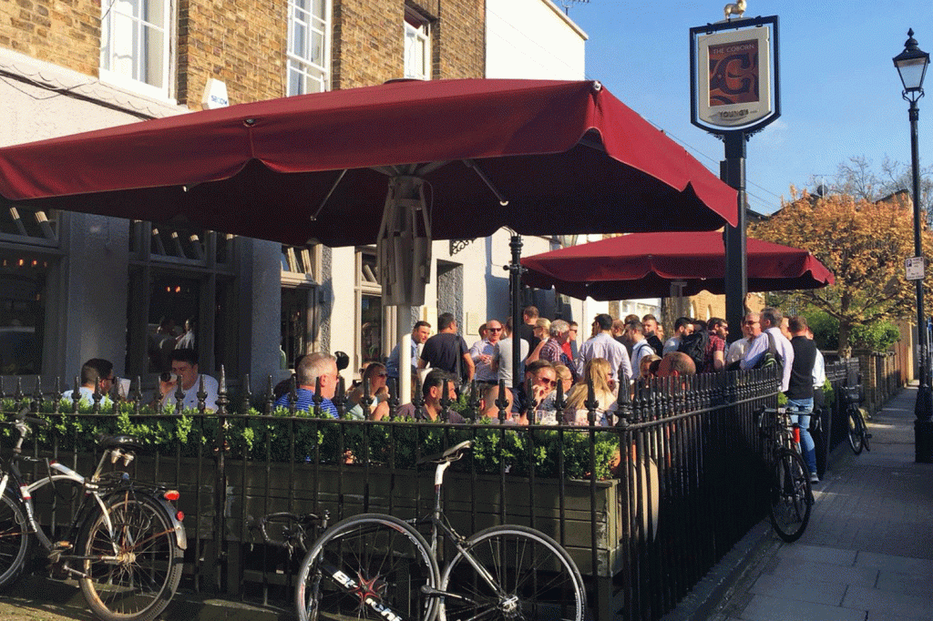 Crowd of people in the beer garden at The Coborn in Mile End, East London