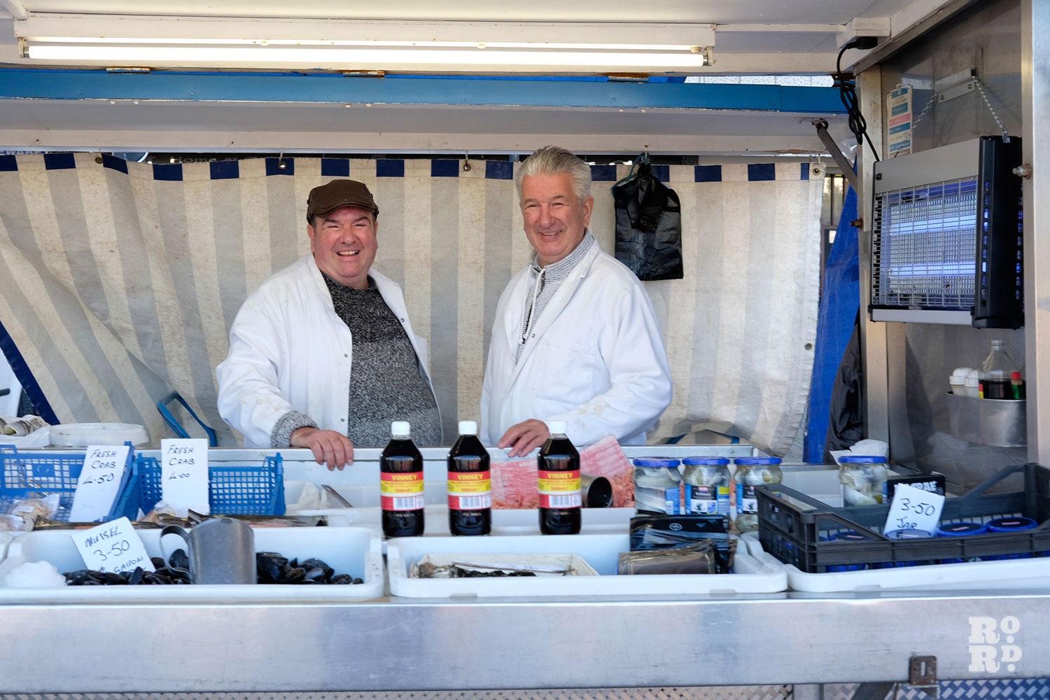 The Downey brothers, fishmonger market stall on Globe Town Market, East London.