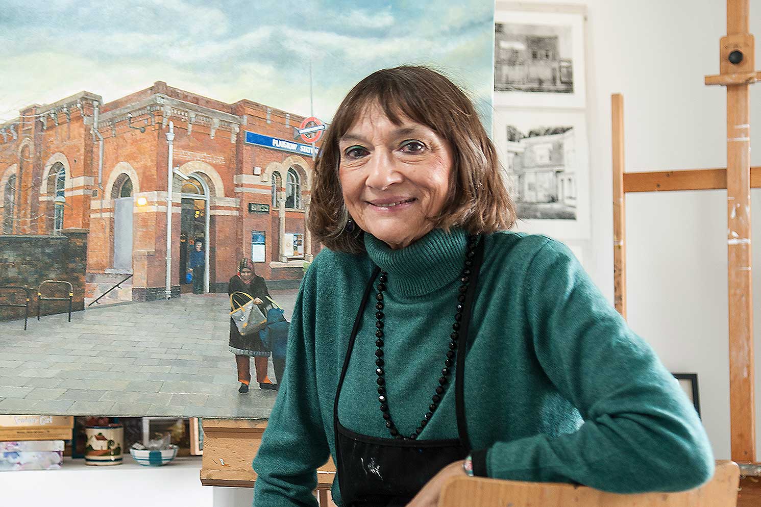 Doreen Fletcher artist posing in front of canvas painting