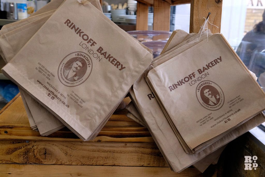 Brown paper bags hang ready for customers to use