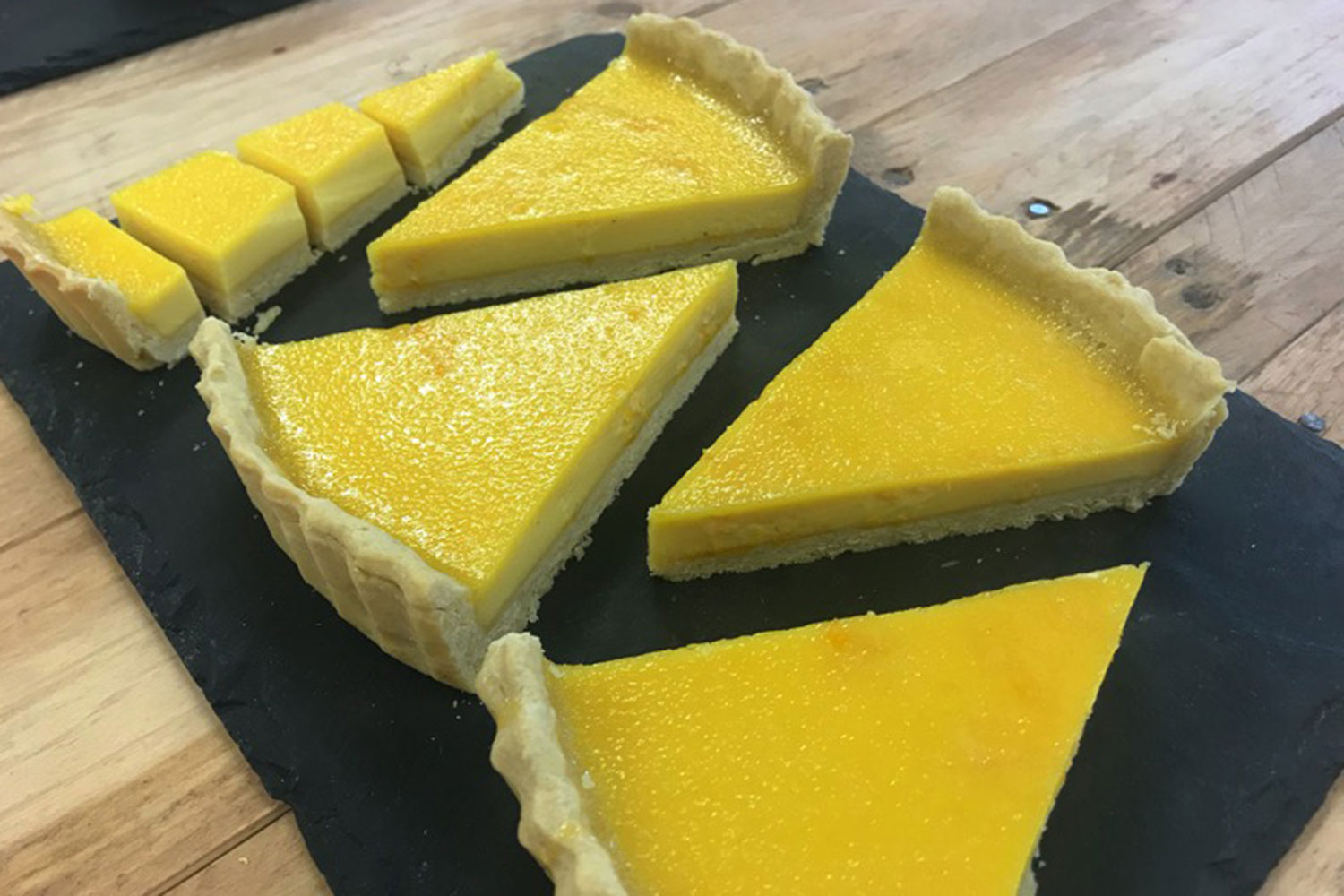 Five slices from a completed lemon custard tart