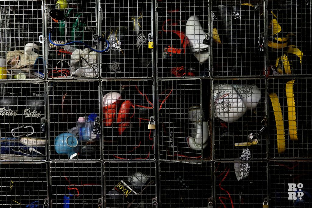 Boxing gloves in cage lockers at KO boxing, Globe Road, East London
