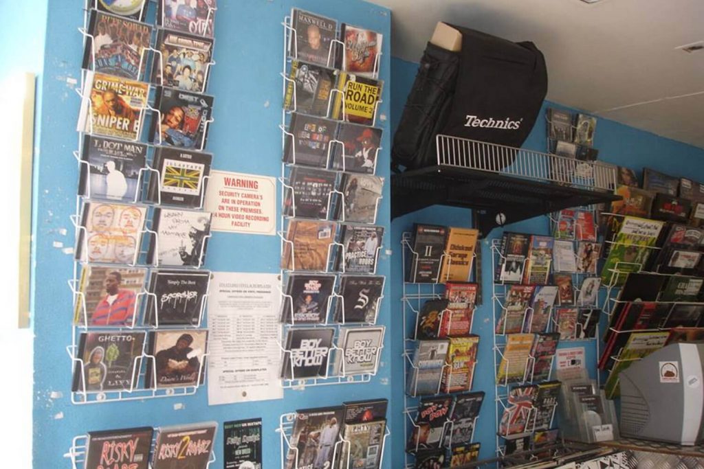 Records and DVDs lining the walls at Rhythm Division in Bow, East London, a community hub for Grime music artists