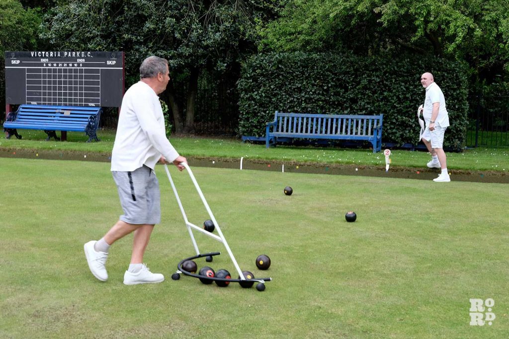Players collect bowls after a game at the Victoria Park Bowls Club in East London