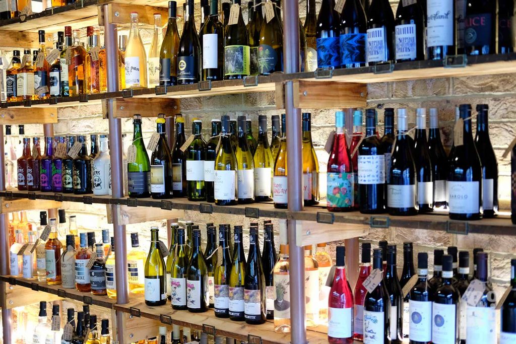 Bottles of wine and spirits on shelves inside BottleJob
