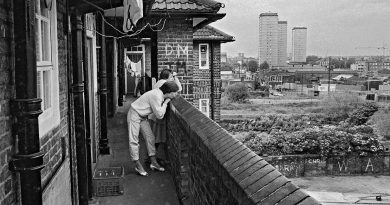 Women staying on the balcony looking out to East London, Isle of Dogs