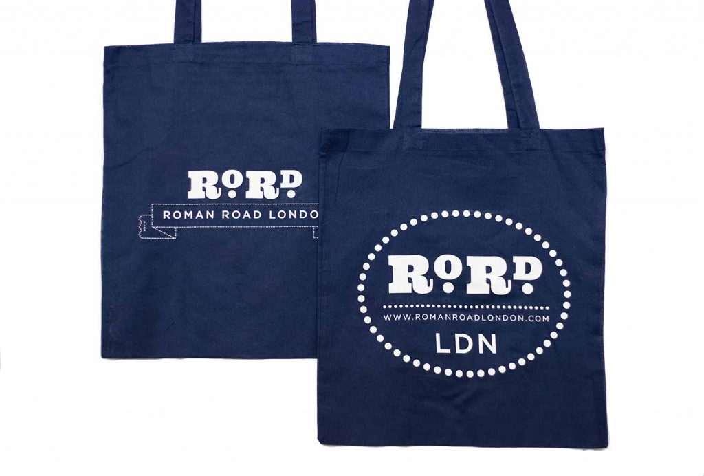 Back and front of navy blue Roman Road LDN shopping top bag.