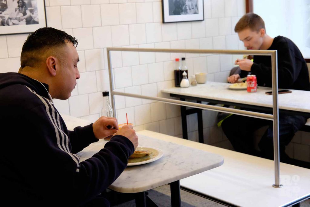 G.Kelly pie and mash Roman Road two customers eating