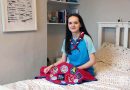 Girl Guide Maud McLaughlin with her camp blanket in bedroom