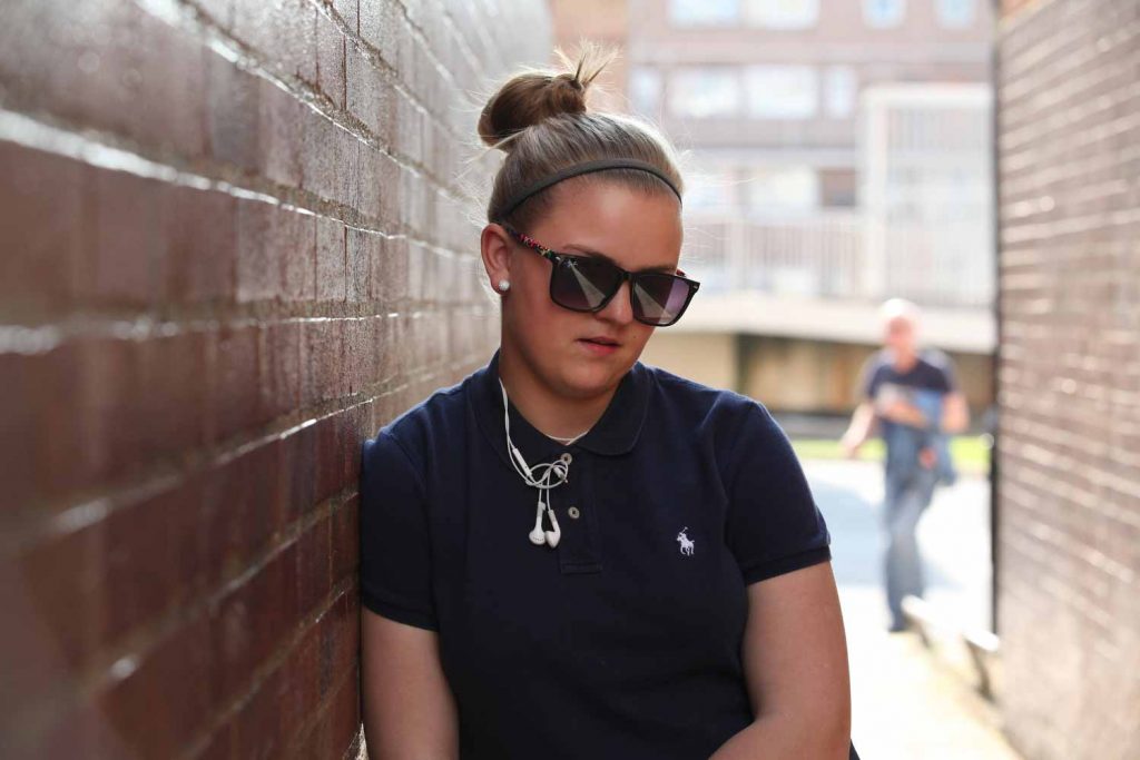 Girl with sunglasses, Wager Street estate in Mile End by photographer Rehan Jamil