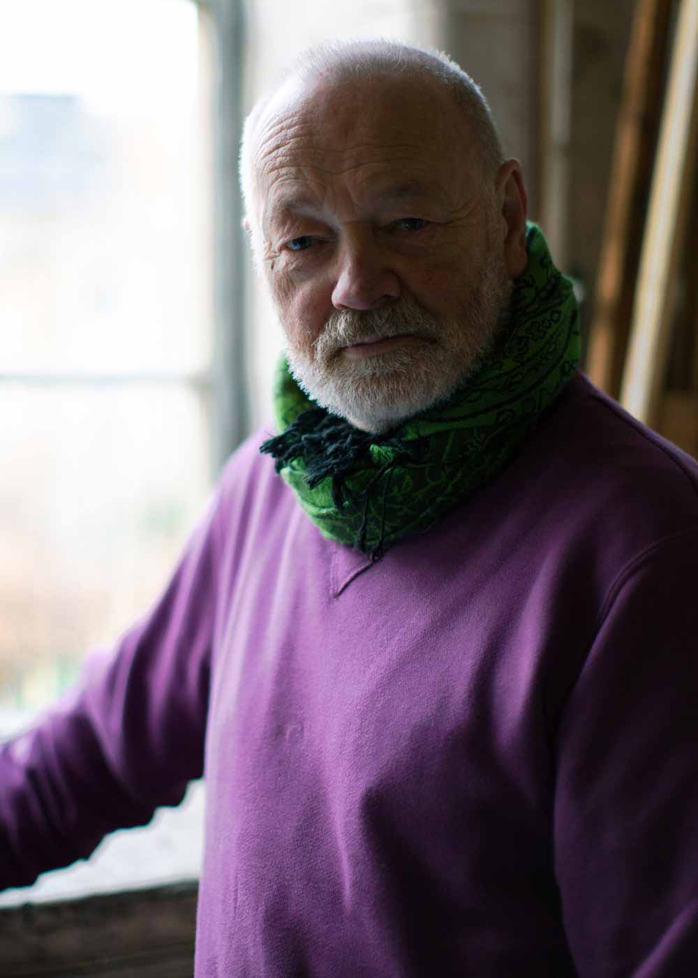 Portait of artist Jon George, wearing purple jumper