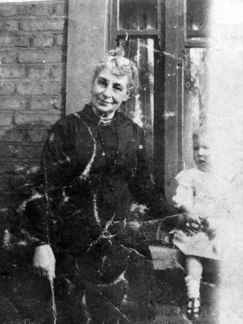 Matchstick girl worker Sarah Chapman with young child outside house