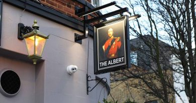 The new pub sign hanging above The Albert at the entrance of Roman Road Market, Bow, East London