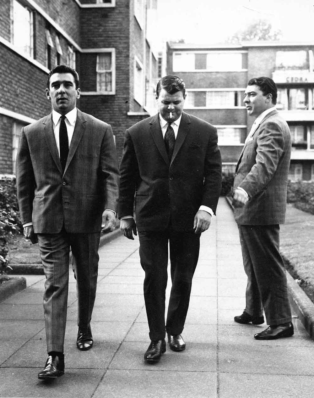 Kray Twins with Squibb walking outside flats in East London