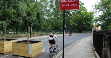 Cyclist approaching Skew Bridge on Old Ford Road, closed to traffic with planters