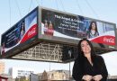 Owner of Angel and Crown pub, Melise Keogh, standing in from of the Coca Cola billboard featuring her business