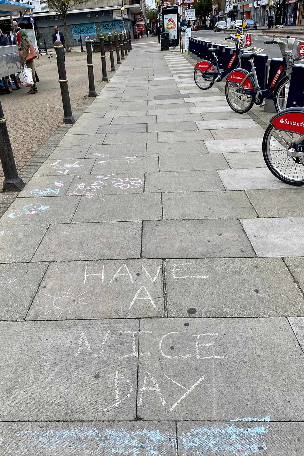 'have a nice day' chalked onto pavement in globe town