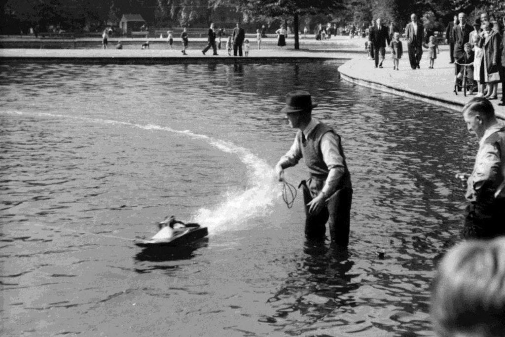 Man launching steam boat in Victoria Park lake