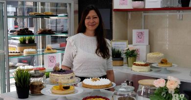 Pam Tironi, owner of the Bakery Room, Roman Road in East London, surrounding by cakes