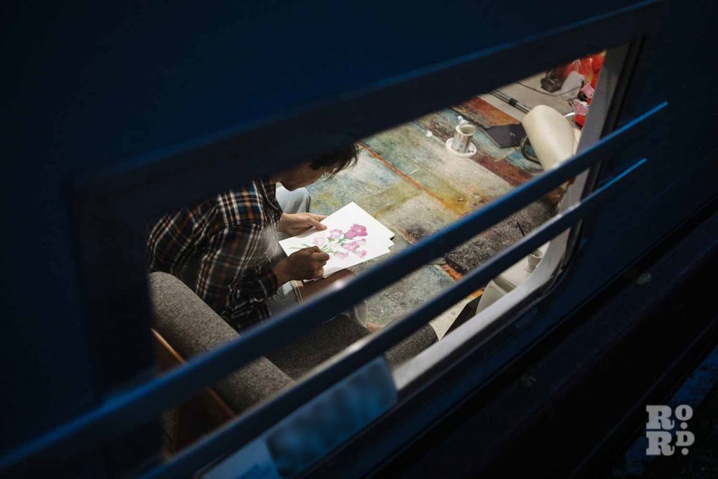 Doing art - a window into canal boats on Regent's Canal, by photographer Rose Palmer