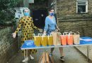 Two volunteers handing out food parcels at Neighbourhood Bites on Roman Road
