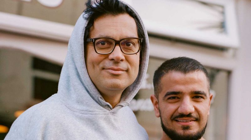Grime photographer Simon Wheatley with Mustafa Has, outside Cafe East on Roman Road in Bow, East London