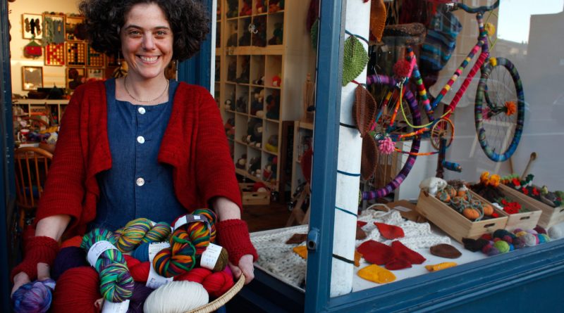 Owner of Wild and Wooly standing outside her knitting supplies shop on Lower Clapton Road