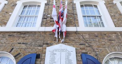 English and British flags over war memorial on Cyprus Street in Bethnal Green, East London.
