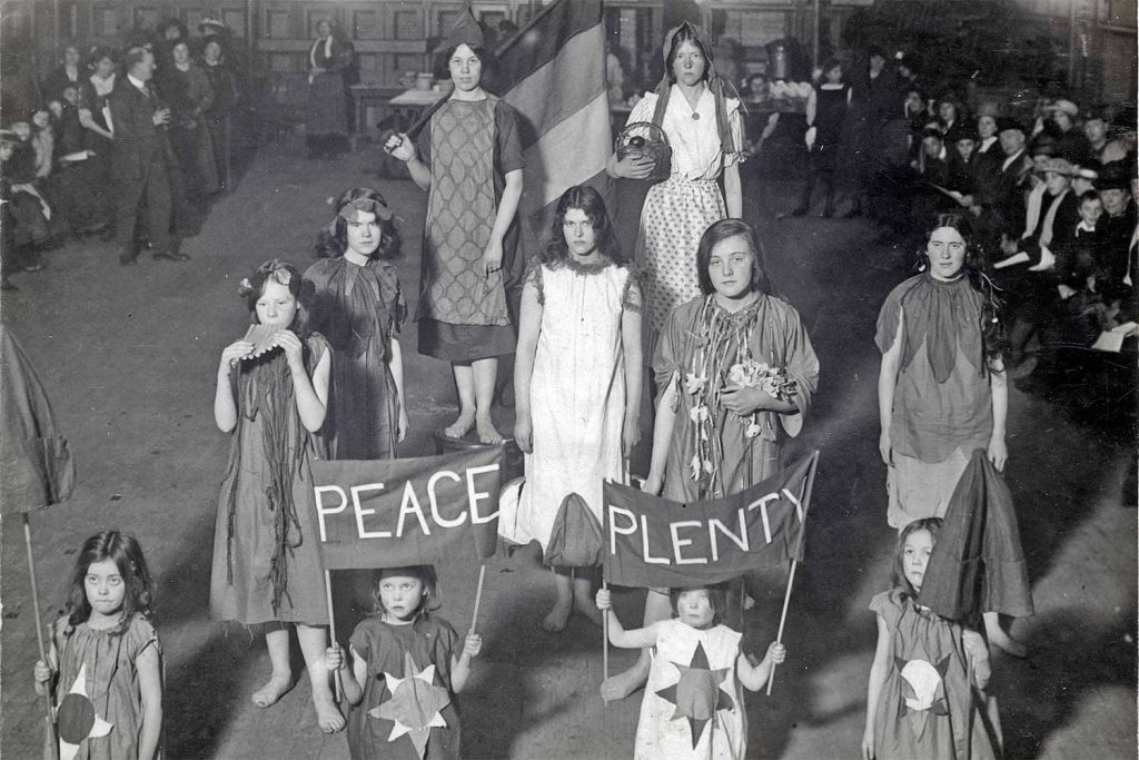 The Junior Suffragettes at the East London Federation of Suffragettes' New year party at Bow baths, East London, in 1916. Middle row, left, sixteen-year-old Rose Pangelly plays the panpipes.