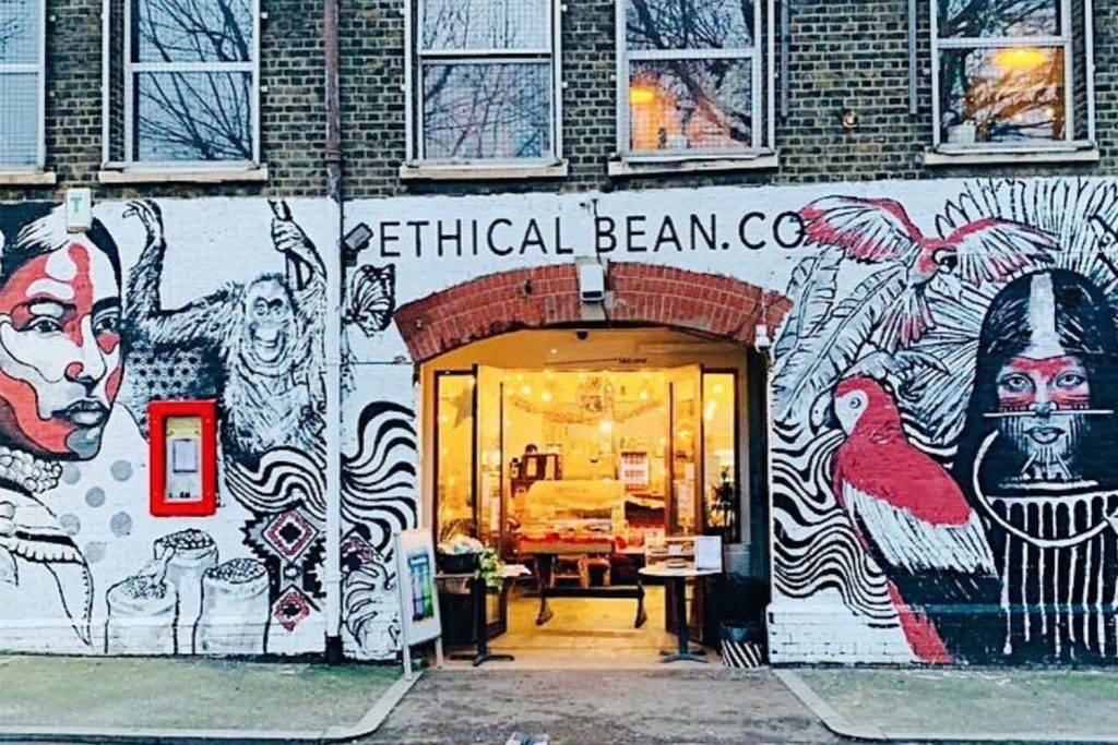 The exterior of Ethical Bean Company, its brickwork covered in art by local artist Luke Gray