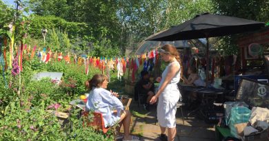 two women stand in the canal club community garden