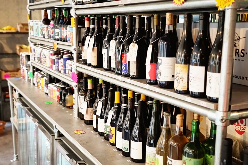 Wine and craft beer on a metal shelf, Tuck Shop, Fish Island, East London