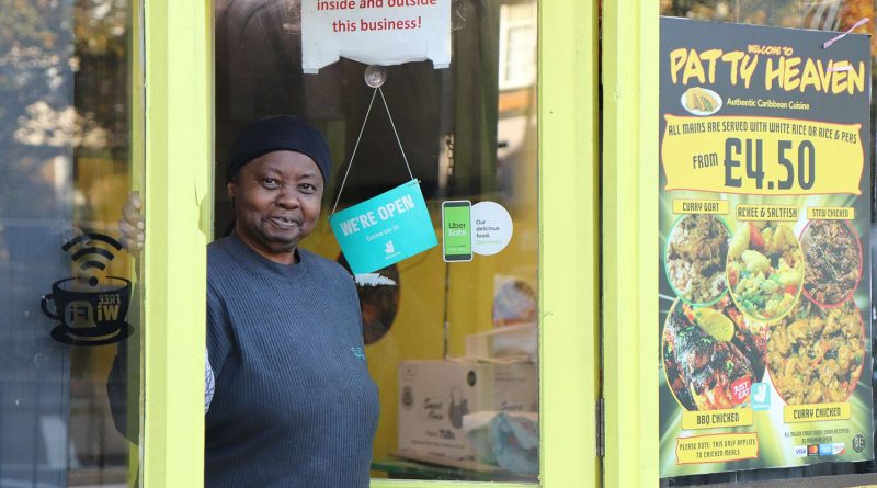 Deslyn, the owner of Patty Heaven outside her little yellow Caribbean food shop on Roman Road.