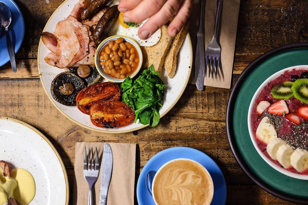 Plate of a full english with coffee, Full Monty, Globe Town, East London
