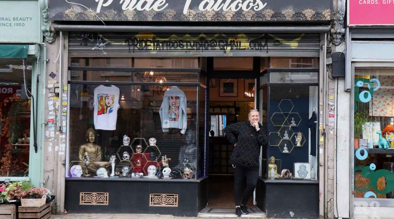 Tracy Buck, standing in front of her shop, Pride Tattos on Roman Road.