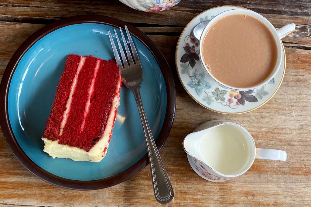 A cup of tea and a slice of red velvet cake at Loafing, Roman Road, Bow, East London.