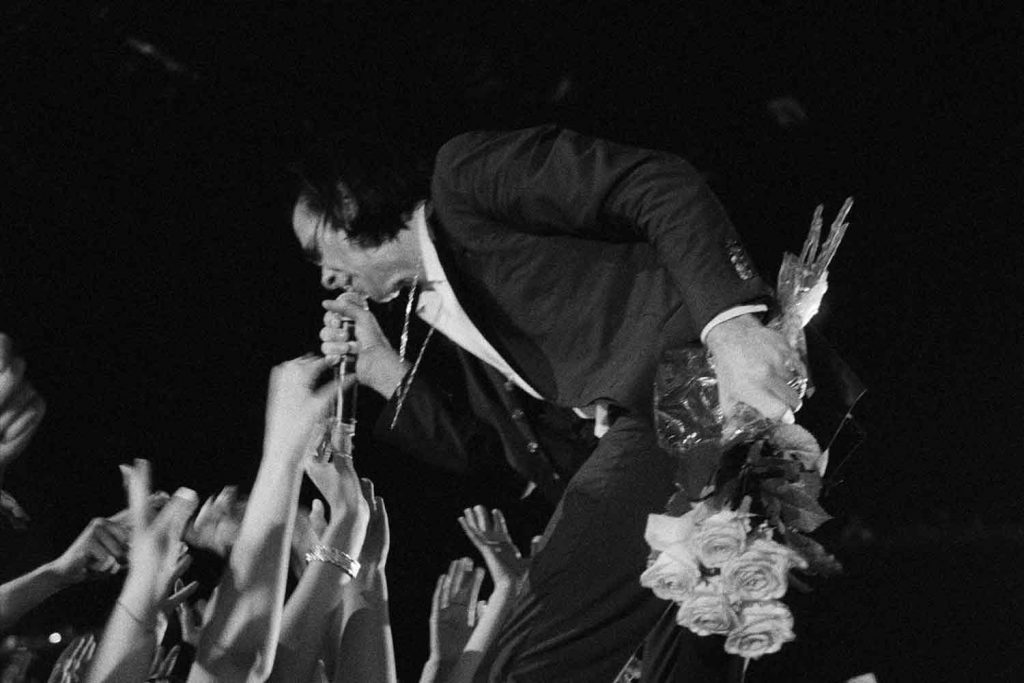 Black and white photograph of Nick Cave and fans