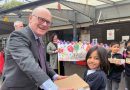 John Biggs pictured with school child in Tower Hamlets