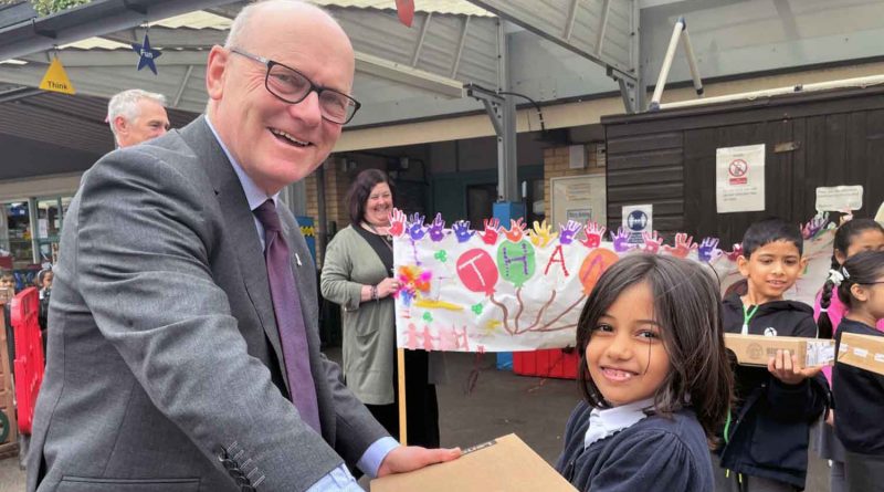 John Biggs pictured with school child in Tower Hamlets