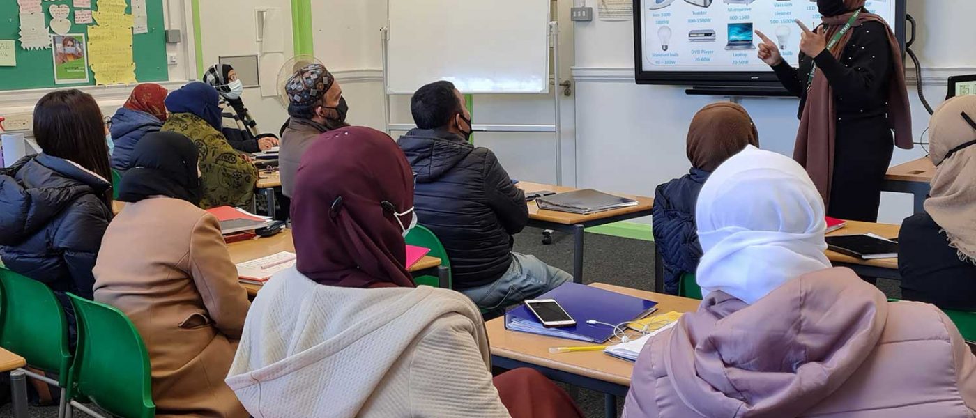 a woman leading a workshop in a classroom in Bromley-by-Bow centre, Bow, East London