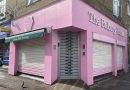 shutters down on pink corner cafe on Roman Road market, Bow, East London