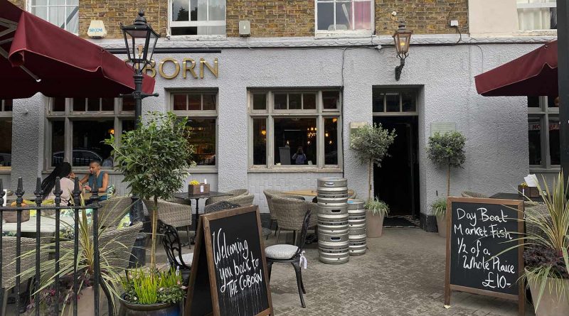 the exterior shot of a pub with beer barrels sitting outside, Coborn Street, Mile End, East London