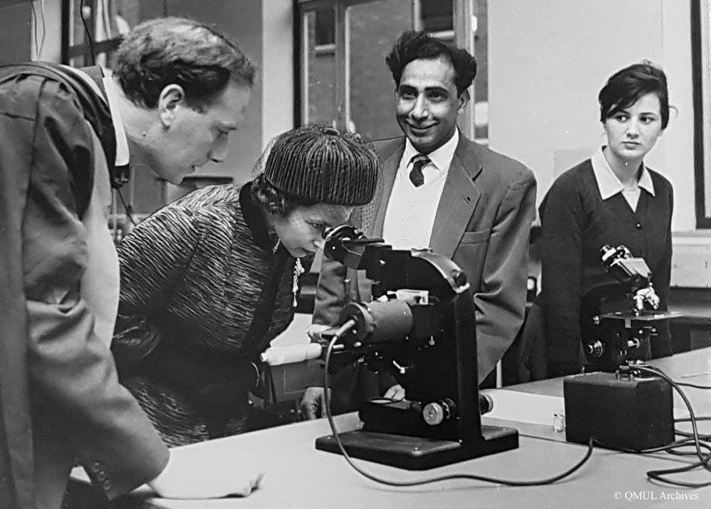 Queen Elizabeth looking down a microscope at Queen Mary University in 1962, East London